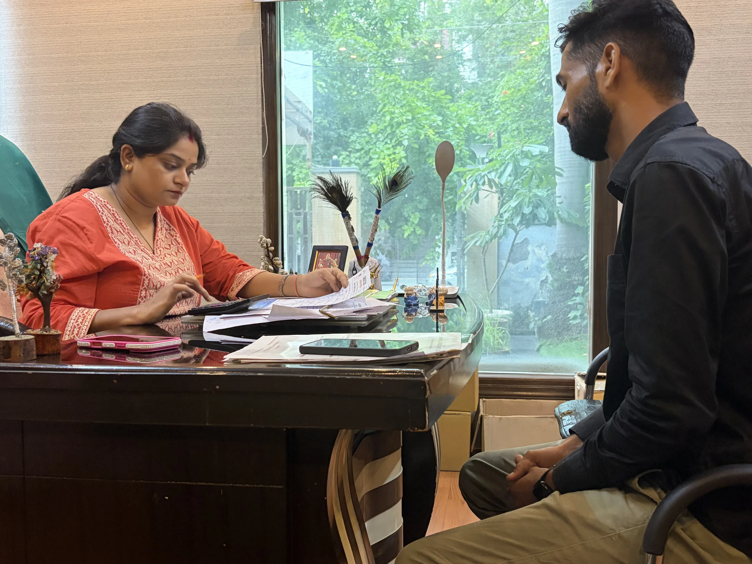 Dr. Neha Mahajan reviewing medical reports during patient consultation